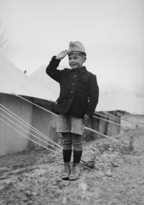 A-young-Polish-refugee-salutes-outside-his-tent.-450x640_213