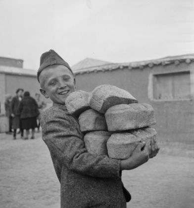A-Polish-boy-carries-loaves-of-bread-provided-by-the-Red-Cro